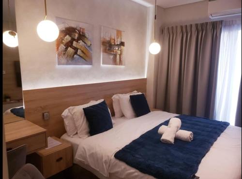 a bedroom with a bed with two towels on it at The Signature Hotel Apartment Accra Ghana in Accra