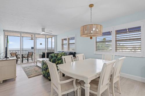フォートマイヤーズビーチにあるBeach Villas # 306 condoのダイニングルーム、リビングルーム(白いテーブル、椅子付)