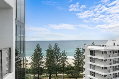 a view of the ocean from a building at Immaculate Burleigh Apartment at Sandbar Burleigh Heads in Gold Coast