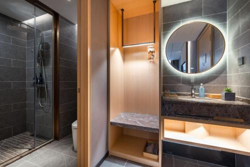 a bathroom with a shower and a sink and a mirror at 雅庭酒店深圳海岸城南山地铁站店 in Shenzhen