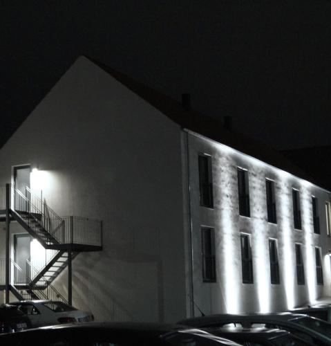 a building with lights on the side of it at night at Hotel Bella Italia in Sønderborg