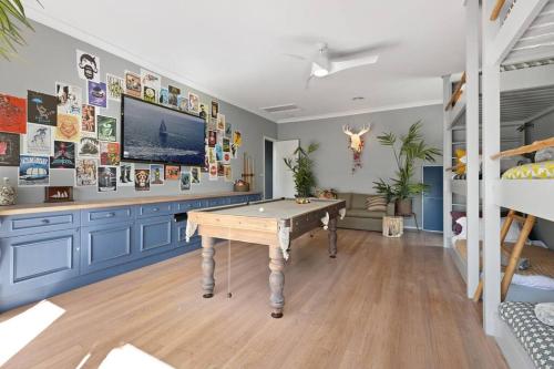 a room with a pool table and a tv at Culburra Beach House in Culburra Beach