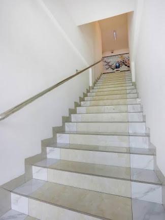 a stairway in a building with a stair case at Rich Hotel in Kampong Ayer Hitam Batu Satu