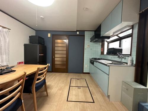 a kitchen with a wooden table and a dining room at West Kamata 5 西蒲本家 in Tokyo