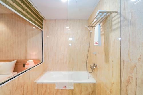 a bathroom with a shower and a sink and a glass shower at MOMIZI Hotel HAI PHONG in Hai Phong