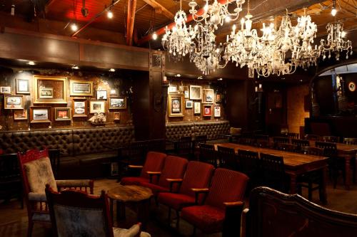 a restaurant with tables and chairs and chandeliers at Quality Inn & Suites in Vancouver