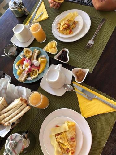 a table topped with plates of food and drinks at La Diguoise in La Digue
