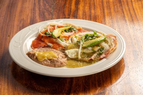 a plate of food with meat and vegetables on a table at Xoot Ka Ana Luxury, Villa Eden in Bacalar