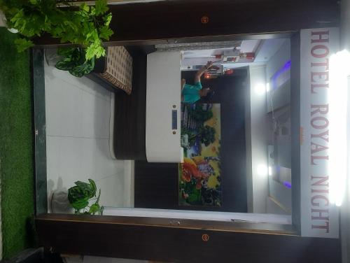 a mirror in a room with a skateboard in it at hotel royal night in Ahmedabad