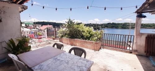 a table and chairs on a balcony with a view of the water at Casa D'Andrea 201 in Flores