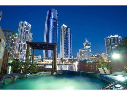 a hot tub with a city skyline in the background at Surfers Reflections Amazing views from your spa! in Gold Coast