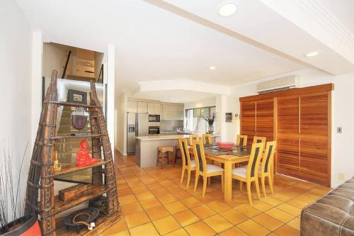 a kitchen and dining room with a table and chairs at Surfers Reflections Amazing views from your spa! in Gold Coast