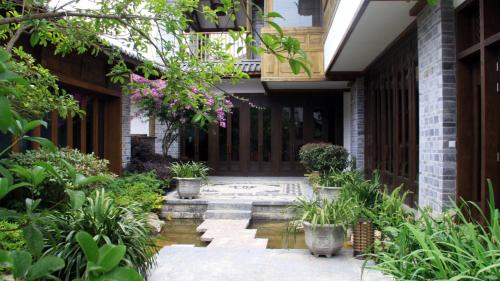 an internal courtyard of a house with plants at Hotel Indigo Lijiang Ancient Town by IHG in Lijiang