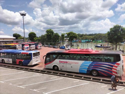 two buses are parked in a parking lot at Ulfah Mersing الفة in Mersing