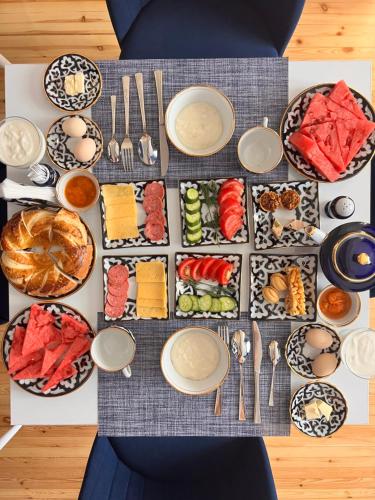 a table full of food with plates and utensils at Anor in Tashkent