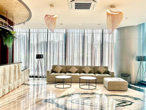 a living room with a couch and two tables at Nemuru Grand Suites in Jakarta
