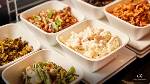 a group of bowls filled with different types of food at Daiwa Roynet Hotel Yokohama-Koen in Yokohama
