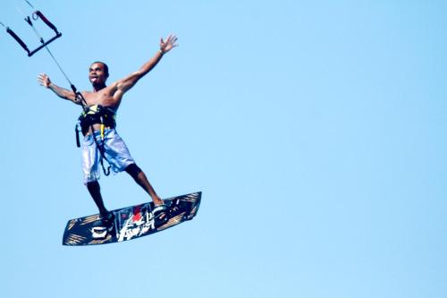 a man flying through the air on a surfboard at Pousada BGK in Barra Grande