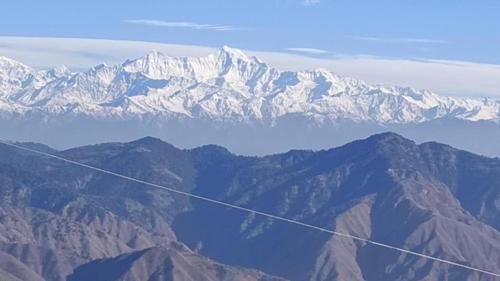 a view of snow covered mountains from an airplane at Burans Breeze in Dhanaulti