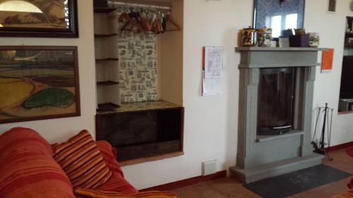 a living room with a fireplace and a couch at La Torretta - Cerreto Grue in Sarezzano