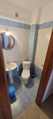 a bathroom with a toilet and a sink at Villa-Alpha in Kassandria