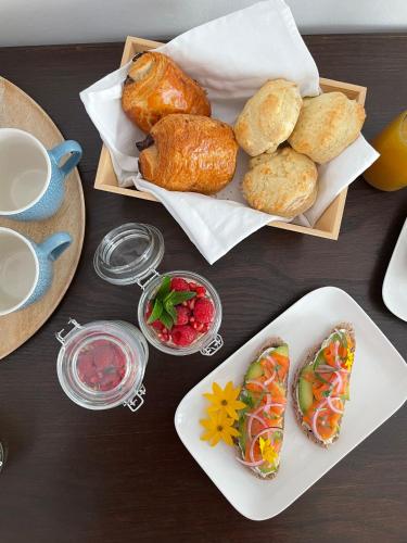 a table topped with plates of food and pastries at Atelier St Jean in Montluçon