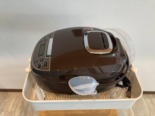 a toaster is sitting in a plastic container at 藤田別荘 in Shodoshima