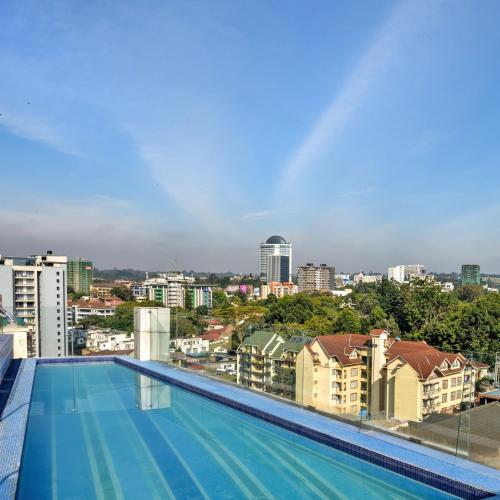 a swimming pool with a view of the city at Novotel Nairobi Westlands in Nairobi