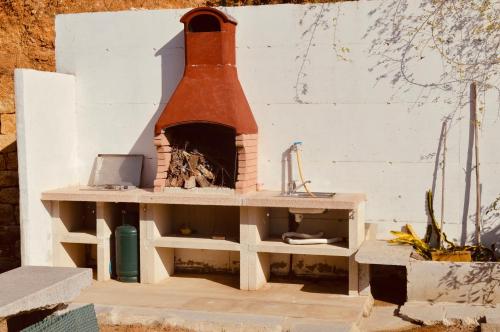 a toy house with a brick oven in a yard at Insula -- Telti in Telti
