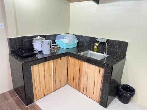 a kitchen with a sink and a counter top at The Catolico's Transient House in Baguio