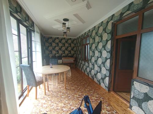 a room with a table and chairs in a room at Fun at the foot of the mountain in Kiş