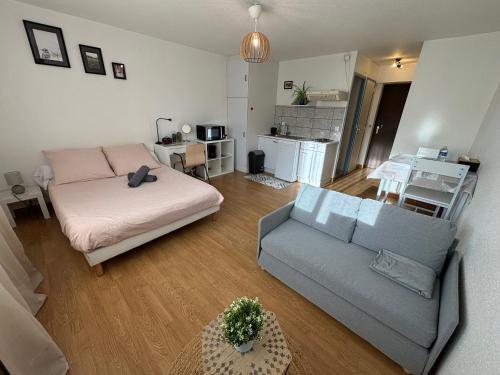 un salon avec un lit et un canapé dans l'établissement Coeur de Perros-Guirec - Studio, à Perros-Guirec