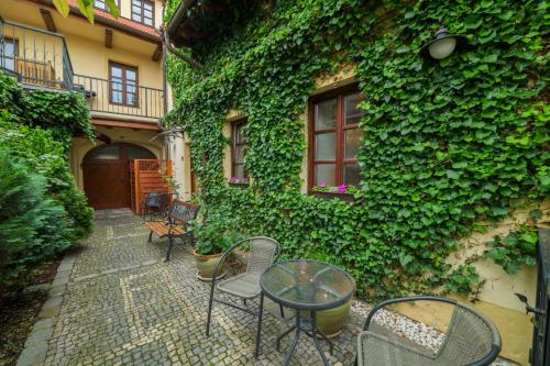 a patio with chairs and tables in front of a building at Penzion U Zámku in Mělník