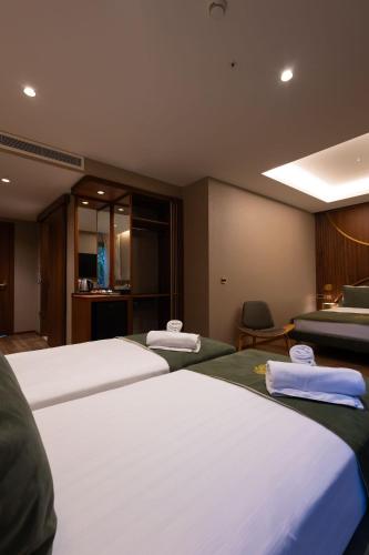 a room with three beds with towels on them at Kate Hotel Special Class & SPA in Istanbul