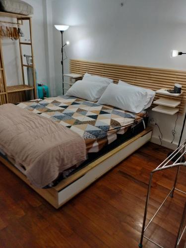 a large bed sitting on a wooden floor in a room at Jayakarta Bali Apartment 6417 in Seminyak