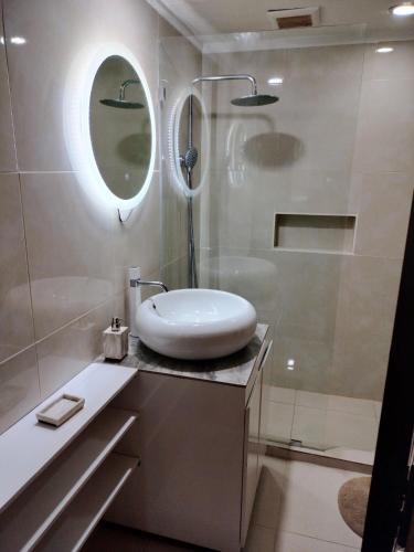 a white bathroom with a sink and a shower at Jayakarta Bali Apartment 6417 in Seminyak