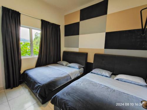 Ένα ή περισσότερα κρεβάτια σε δωμάτιο στο Cameron Homestay