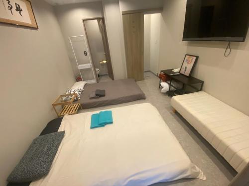 Postel nebo postele na pokoji v ubytování 54Journey Roppongi