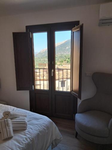 a bedroom with a bed and a window with a view at Dolce-Giardino in Isnello