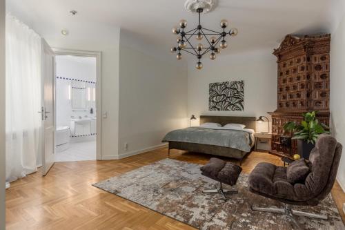 a bedroom with a bed and two chairs at K1820 Family apartments in Rīga
