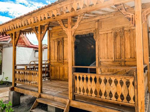 an outside view of a wooden porch of a house at Mimpi Bungalow in Gili Meno
