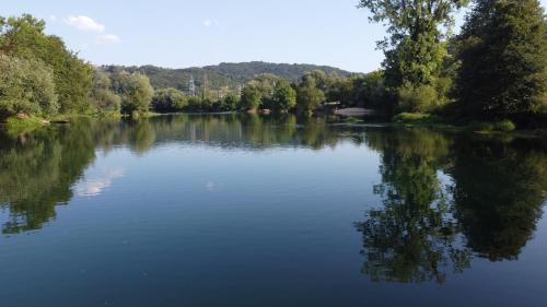 a view of a river with trees in the background at Unatime.Krupa in Bosanska Krupa