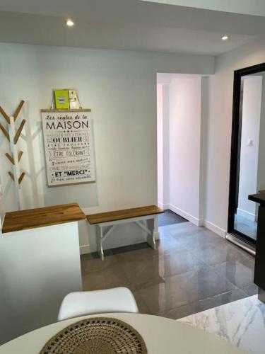a living room with a bench and a table at Duplex neuf cosy centre Seclin in Seclin