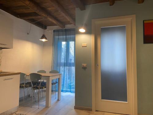 a kitchen and dining room with a table and chairs at PRIMA DEL CIELO - appartamento LAGO in Esino Lario