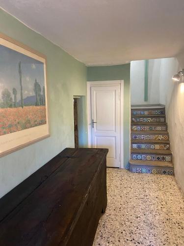 a room with a bed and a painting on the wall at PRIMA DEL CIELO - appartamento LAGO in Esino Lario