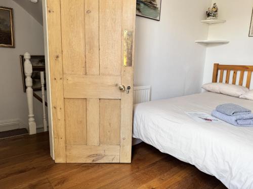 a wooden door in a room with a bed at Cozy Place in Oxford