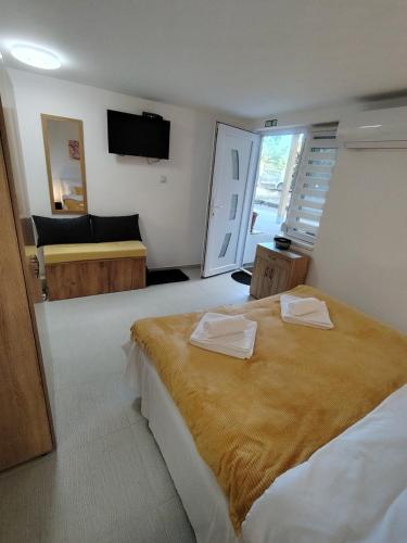 a bedroom with a bed with two towels on it at AGAPE in Leskovac