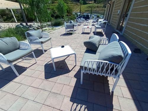 a group of chairs and a table on a patio at LA PIANETTA case vacanze in Palidoro