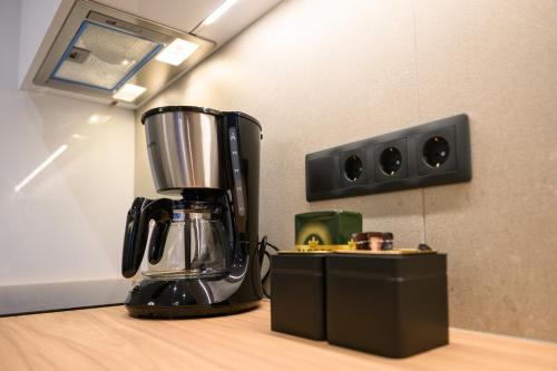 a black blender sitting on top of a counter at Hidden Gem by the Sea in Artemida