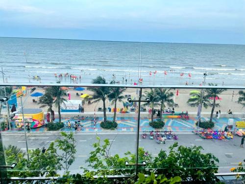 a view of a beach and the ocean from a building at Flamingo Hải Tiến - Căn góc 2 Phòng - View 2 mặt biển in Thanh Hóa